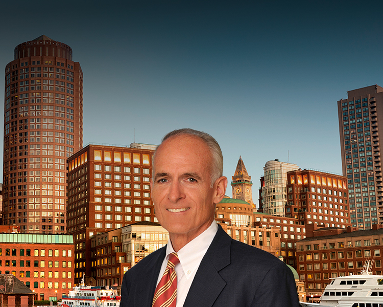 Thomas M. Greene in a suit with city skyline in the background.